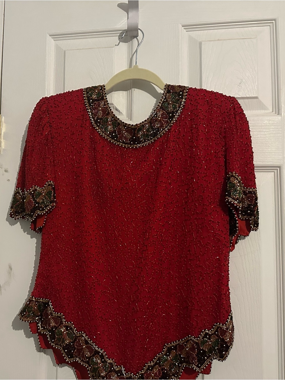 Vibrant red silk heavily embellished with shimmering red seed and bugle beads